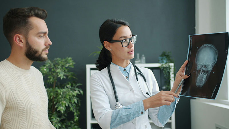 doctor and patient looking at an X-ray